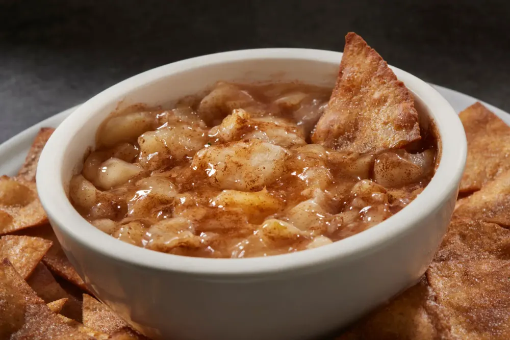 A bowl of spiced apple with cinnamon