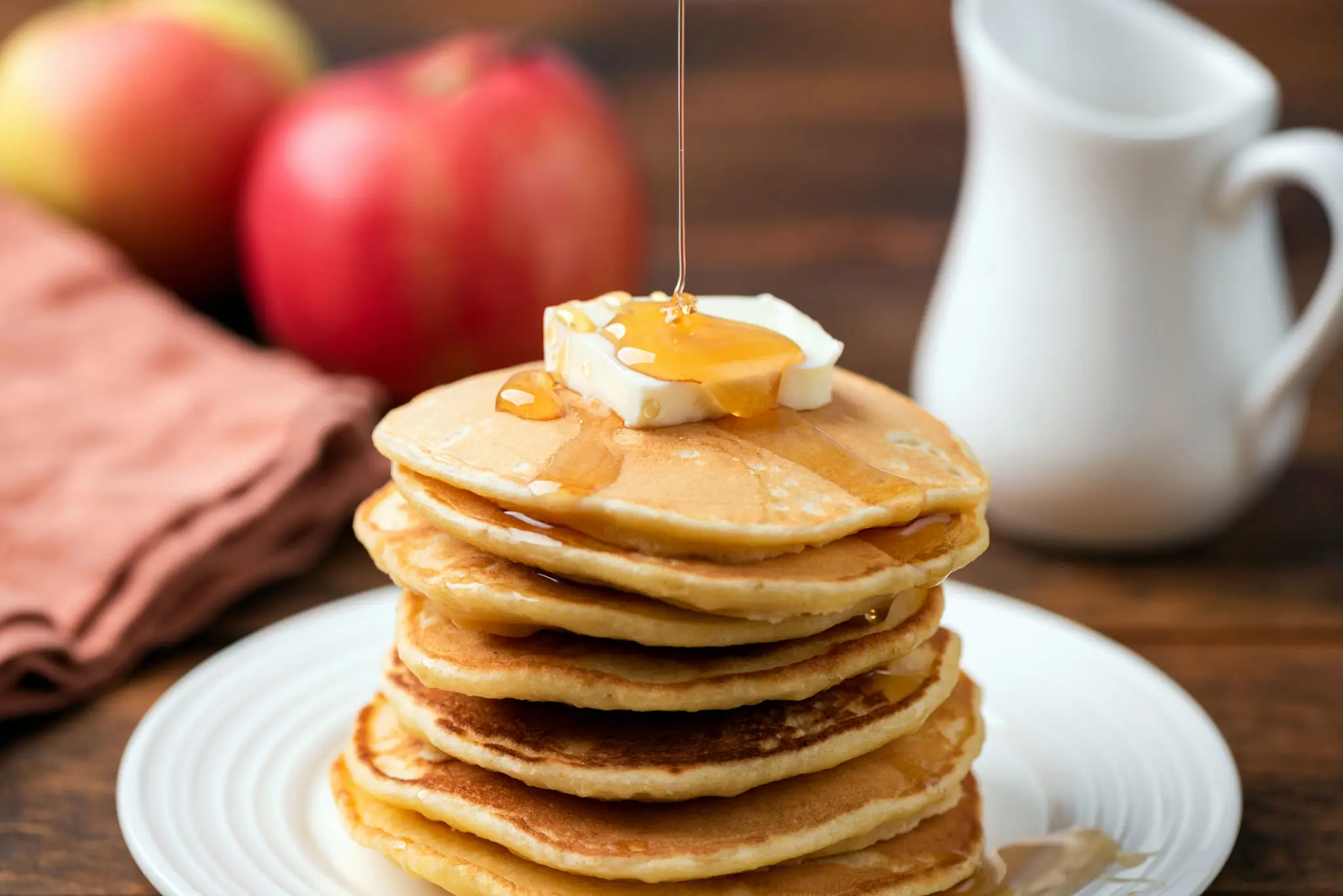 A classic stack of pancakes with butter and cinnamon syrup